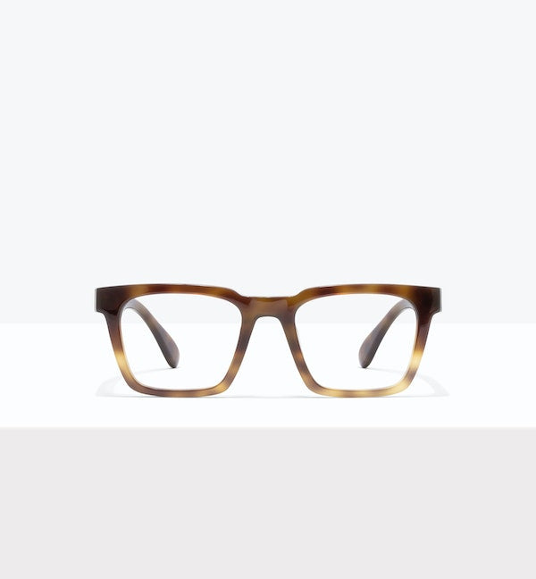 Brown round eyeglasses displayed on a white surface.