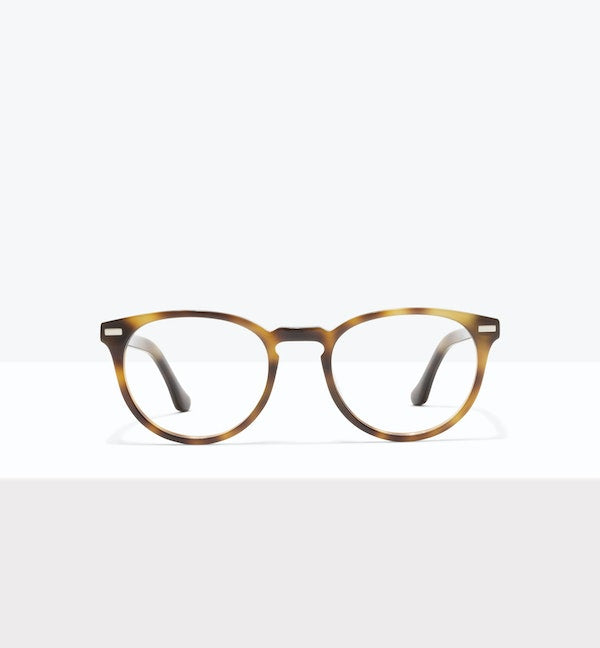 Tortoiseshell glasses resting on a granite stone surface.