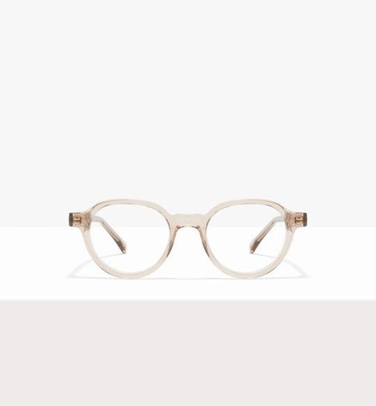 Lunettes Rondes transparentes avec une monture beige translucide.