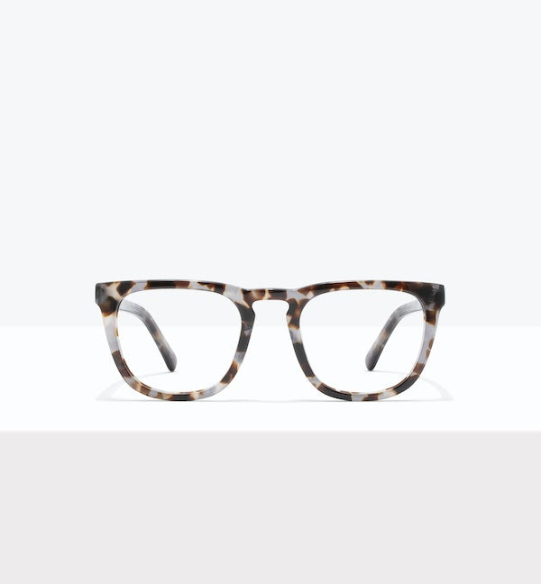 Tortoiseshell rectangular eyeglasses on a white surface.